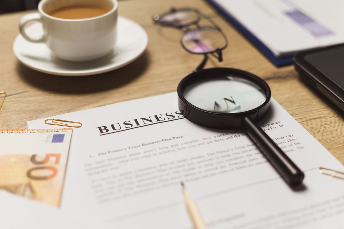 A magnifying glass resting on a printed contract.