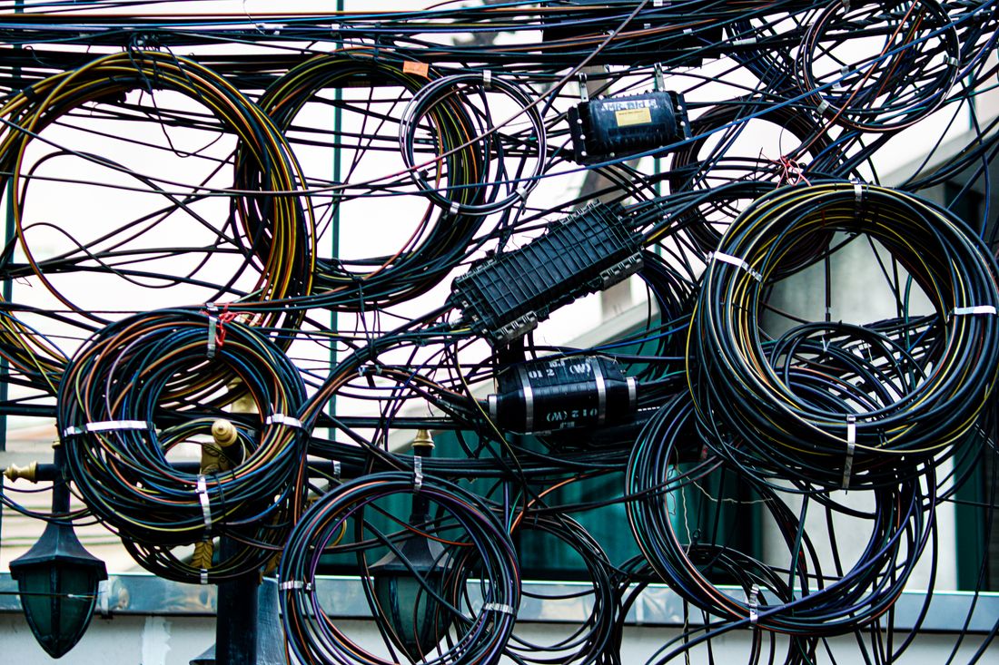 A dense tangle of coloured cables running through a junction.