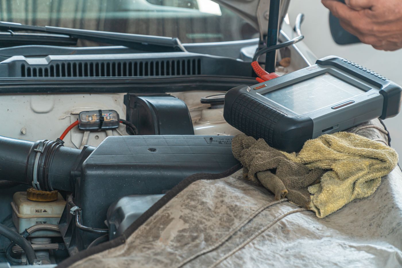 A service technician taking tools from the back of a work van.