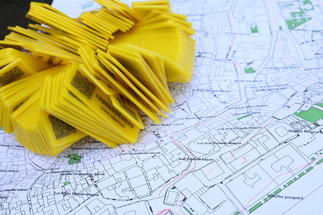 A map spread on a table with location markers placed across it.